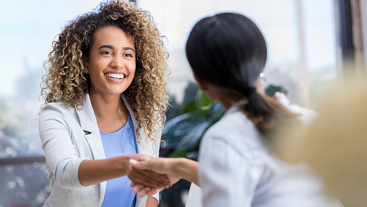 Business women shaking hands