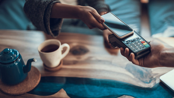 Person paying coffee with mobile phone