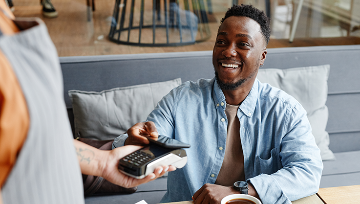 Man tapping phone to pay