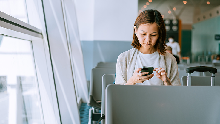 Woman checking expenses on phone